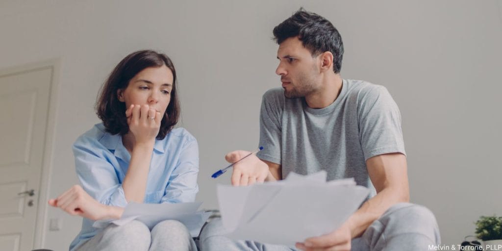 Couple reviewing bank statements showing financial warning signs spouse is planning a divorce